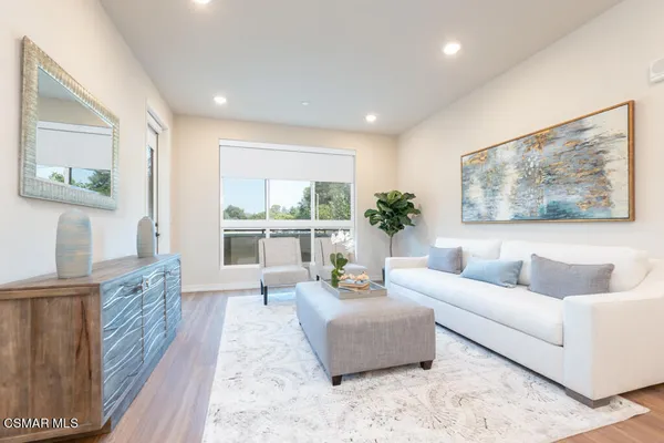 a living room with furniture and a large window