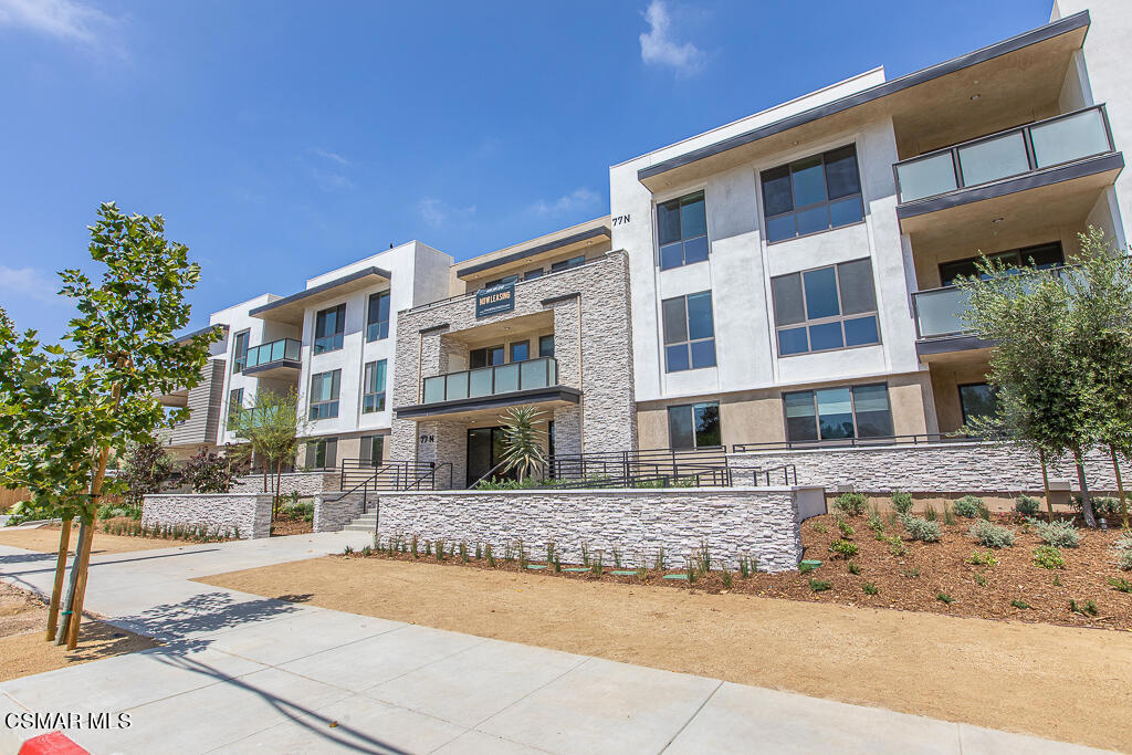 77 North Conejo School Road, Unit 208 Thousand Oaks, CA 91362 - Photo 27 of 27 a front view of a building with a yard