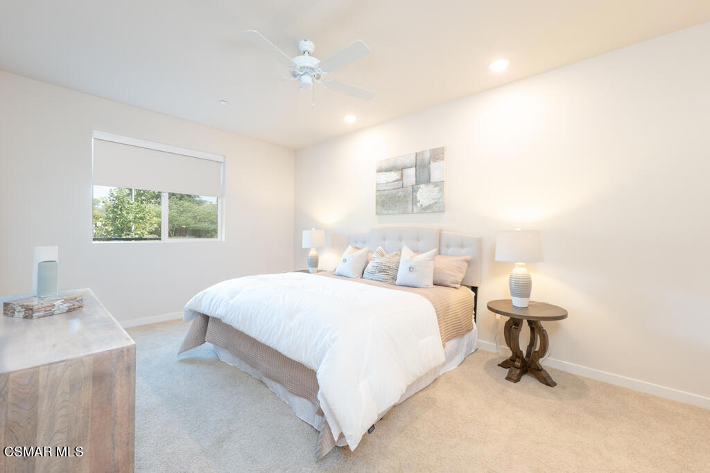 77 North Conejo School Road, Unit 208 Thousand Oaks, CA 91362 - Photo 7 of 27 a bedroom with a bed and a table in it