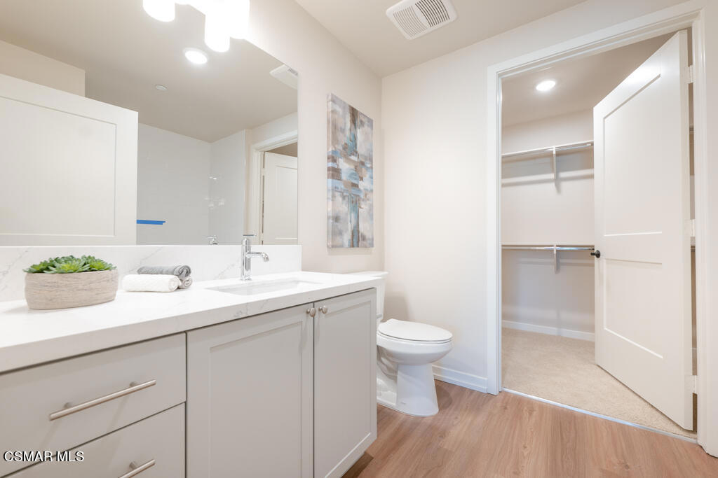 77 North Conejo School Road, Unit 208 Thousand Oaks, CA 91362 - Photo 8 of 27 a bathroom with a sink a toilet and a mirror