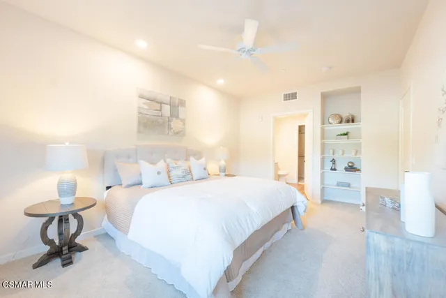 a bedroom with a bed and a table in it