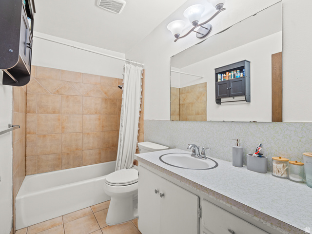 460 200 South Provo, UT 84606 - Photo 48 of 66 Full bathroom featuring vanity, shower / tub combo with curtain, light tile patterned flooring, and tasteful backsplash