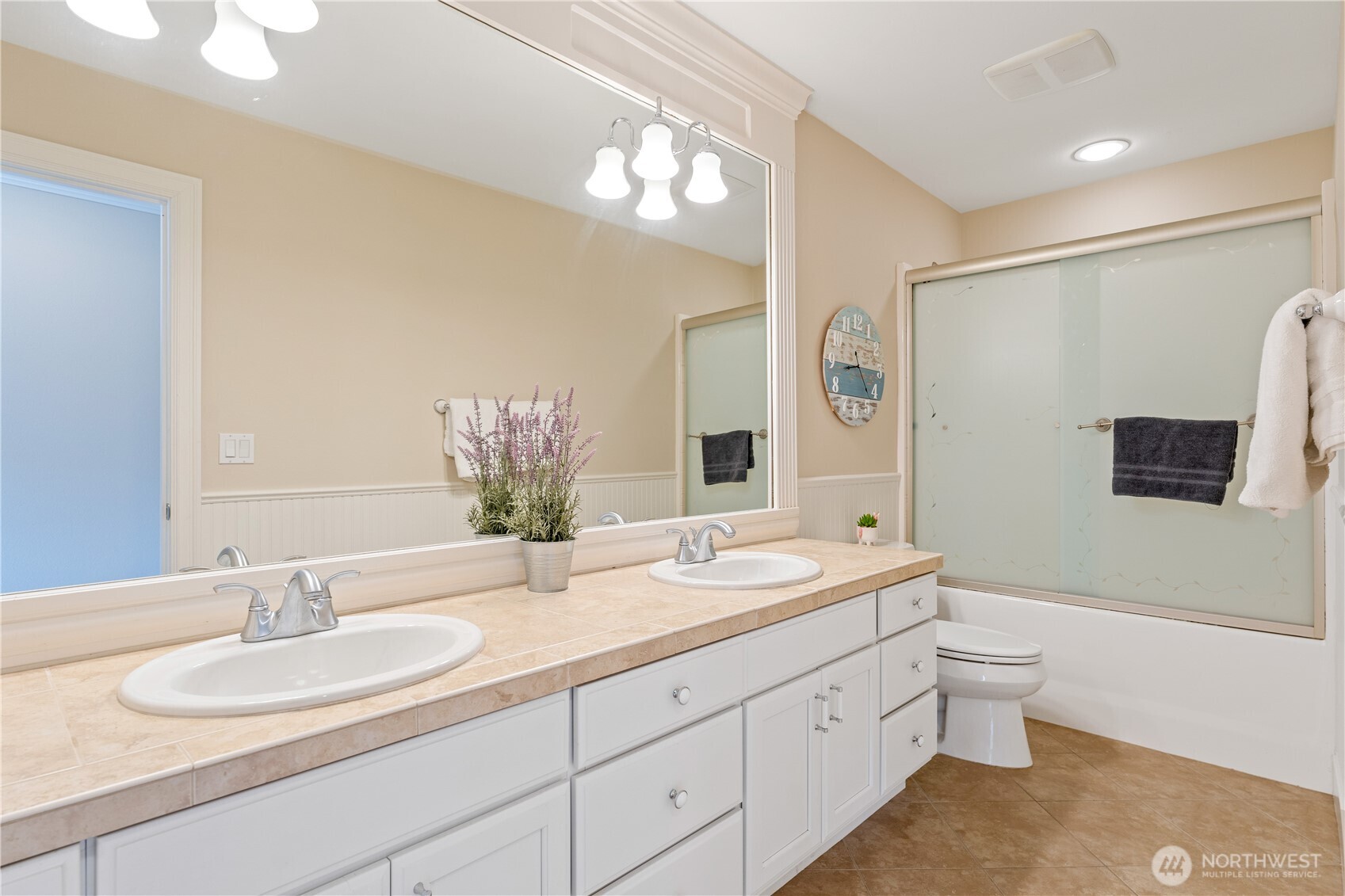 60 Wall Street Manson, WA 98831 - Photo 22 of 40 a bathroom with a double vanity sink and a mirror