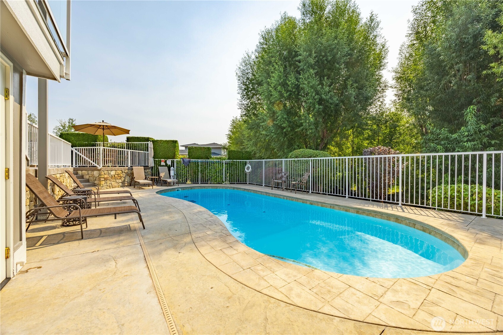 60 Wall Street Manson, WA 98831 - Photo 29 of 40 a view of a swimming pool with a lounge chair