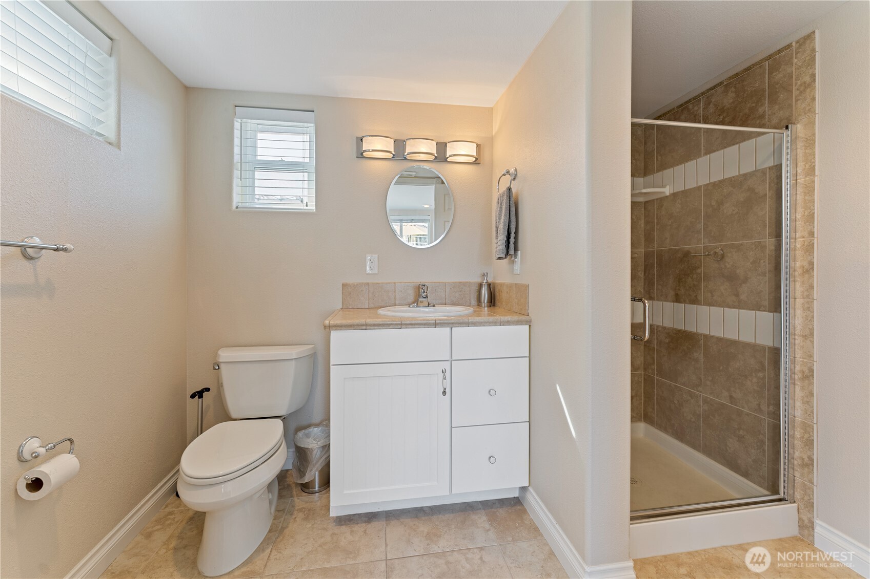 60 Wall Street Manson, WA 98831 - Photo 33 of 40 a bathroom with a granite countertop toilet a sink and a mirror