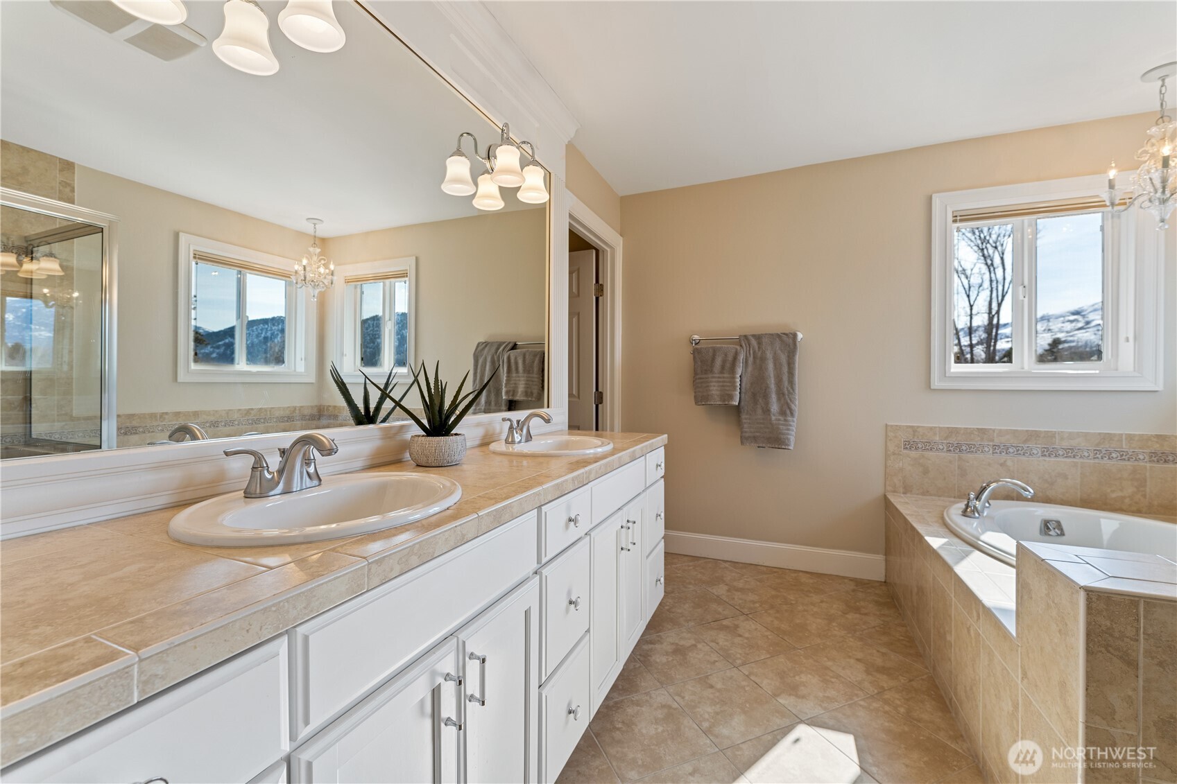 60 Wall Street Manson, WA 98831 - Photo 7 of 40 a spacious bathroom with sinks granite countertop tub and a mirror