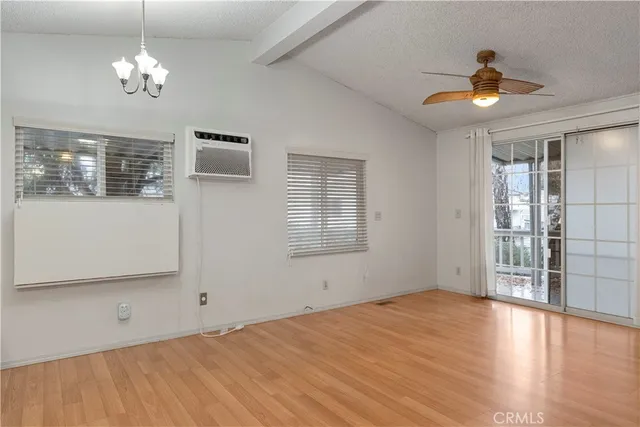 a view of a livingroom with a ceiling fan and window