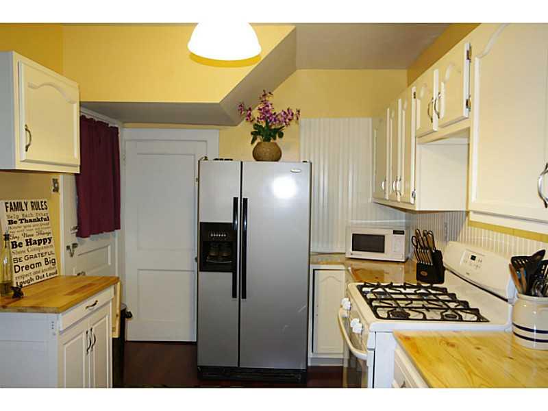 Kitchen. Updated kitchen features new countertops. flooring and appliances. Microwave oven and refrigerator included.