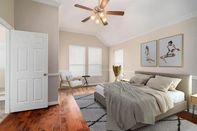 a bedroom with a large bed and a chandelier