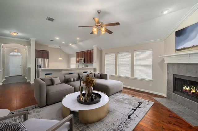 a living room with furniture and a fireplace