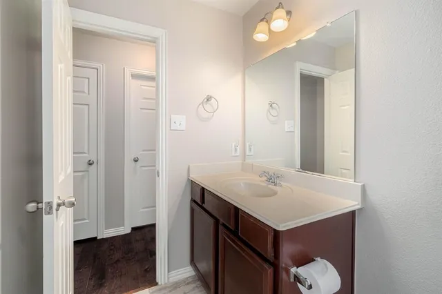 a bathroom with a sink vanity and a mirror