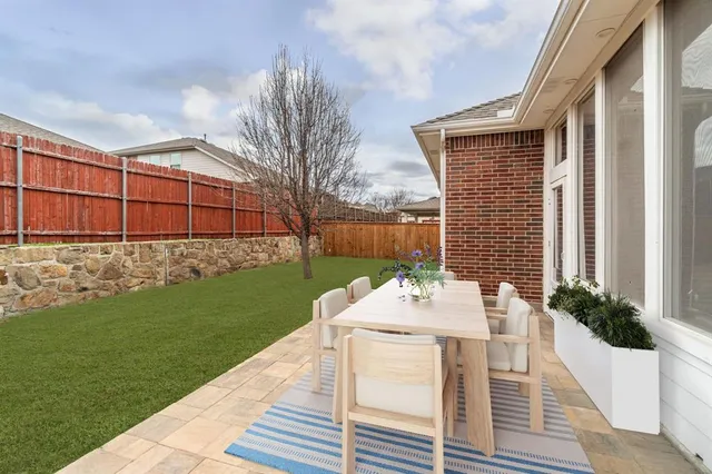 a view of a patio with table and chairs and potted plants