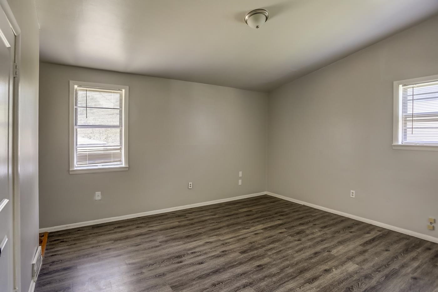 4566 Applegate Road Memphis, TN 38109 - Photo 14 of 25 an empty room with wooden floor and windows
