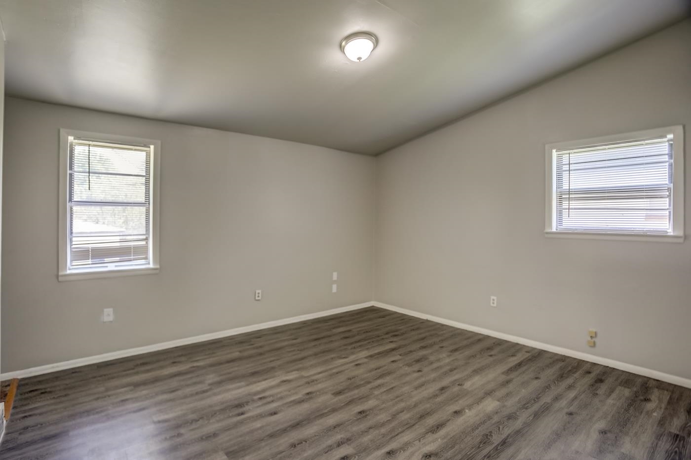 4566 Applegate Road Memphis, TN 38109 - Photo 17 of 25 an empty room with wooden floor and windows