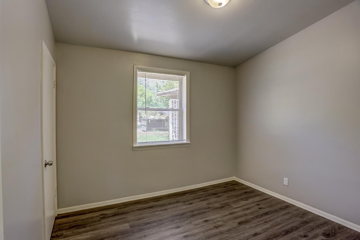 4566 Applegate Road Memphis, TN 38109 - Photo 21 of 25 an empty room with wooden floor and windows