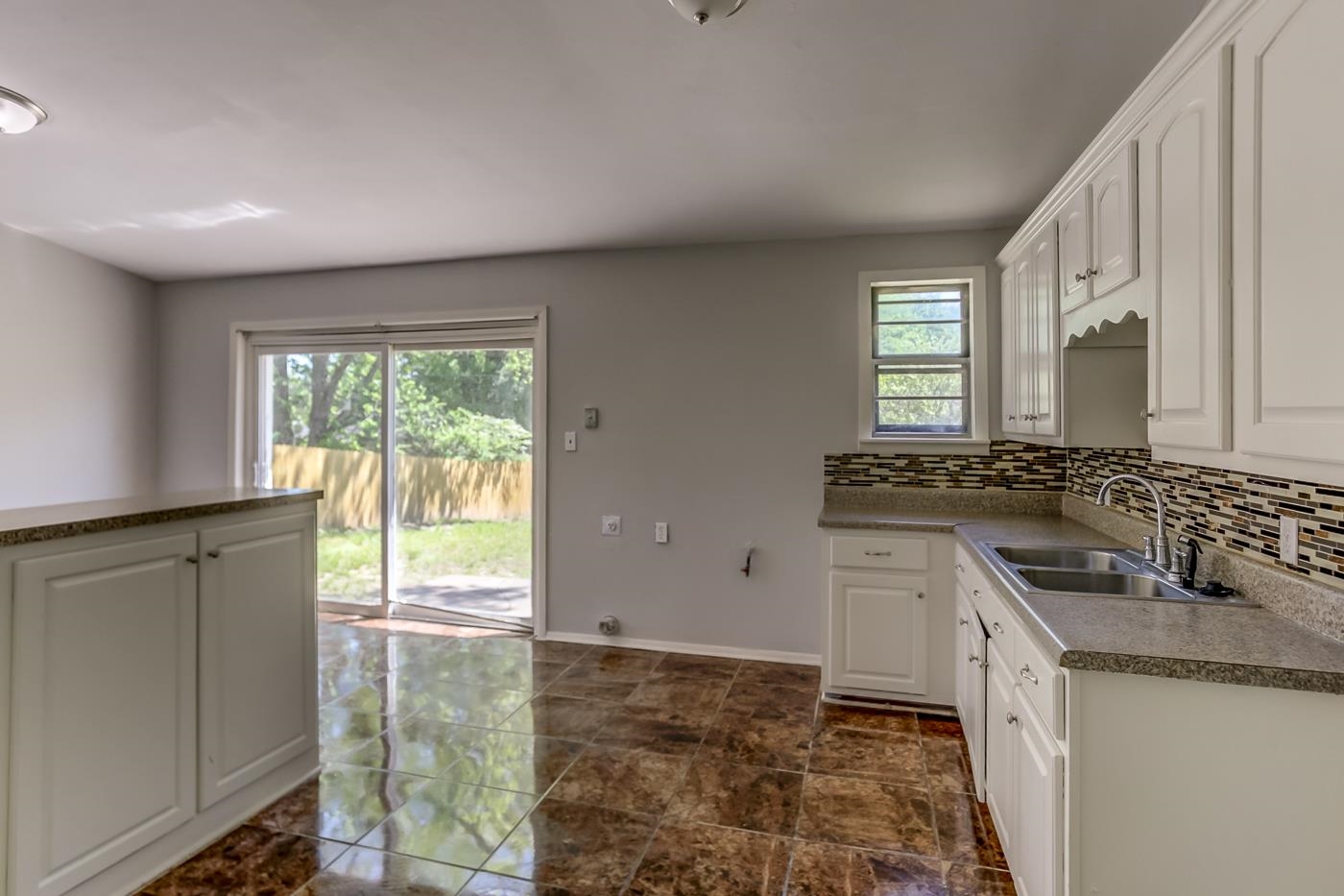 4566 Applegate Road Memphis, TN 38109 - Photo 6 of 25 a kitchen with granite countertop a sink and a stove