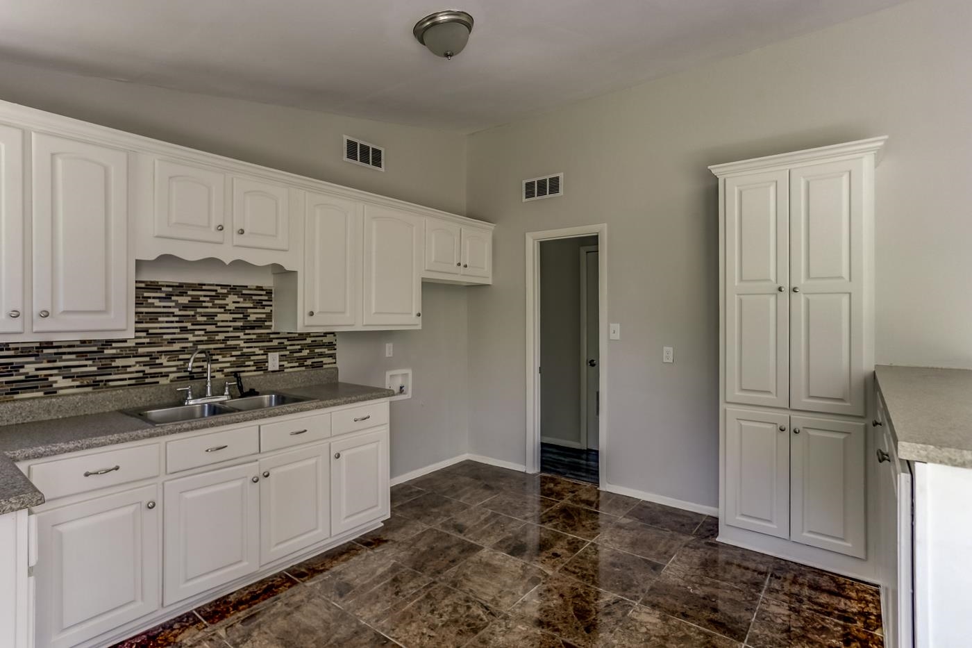 4566 Applegate Road Memphis, TN 38109 - Photo 7 of 25 a kitchen with granite countertop a sink stainless steel appliances and cabinets