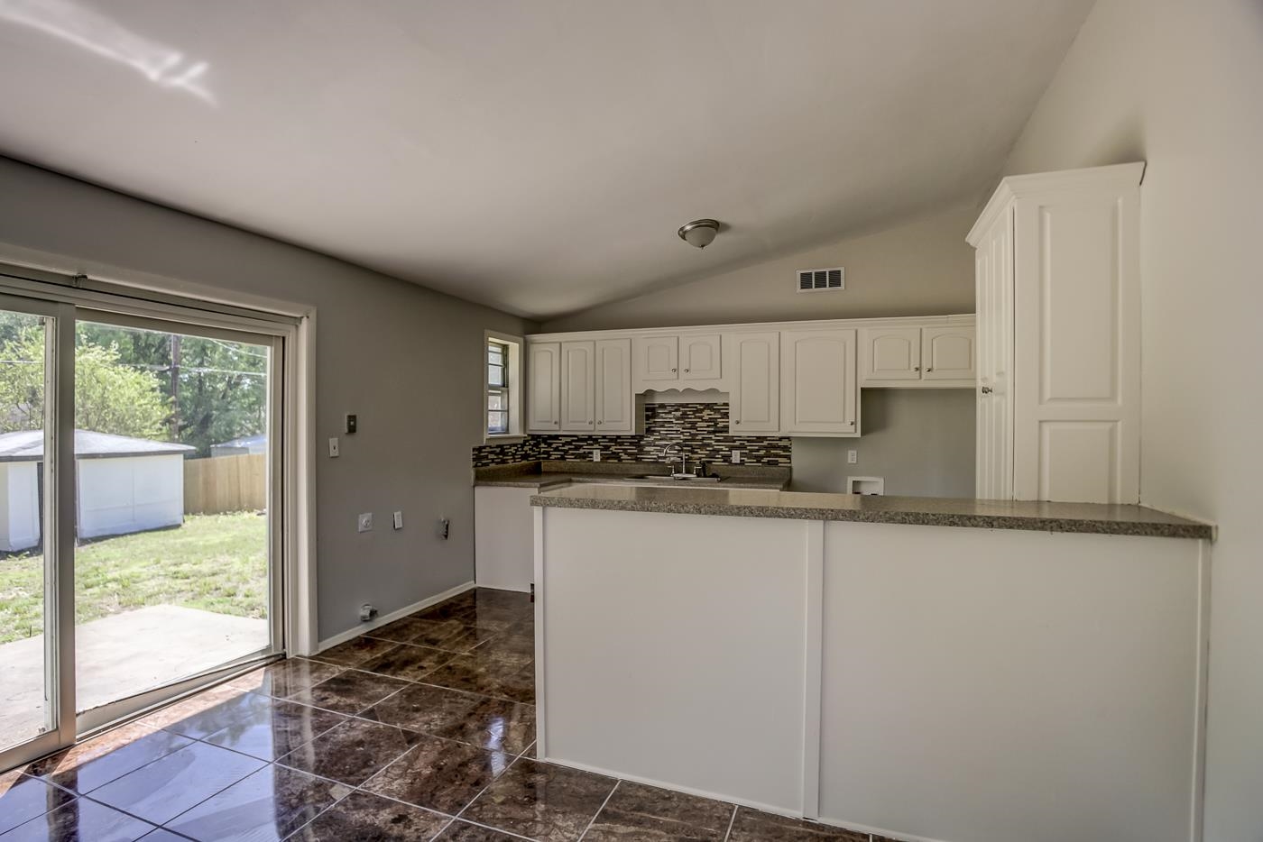 4566 Applegate Road Memphis, TN 38109 - Photo 9 of 25 a kitchen with granite countertop a refrigerator and a sink