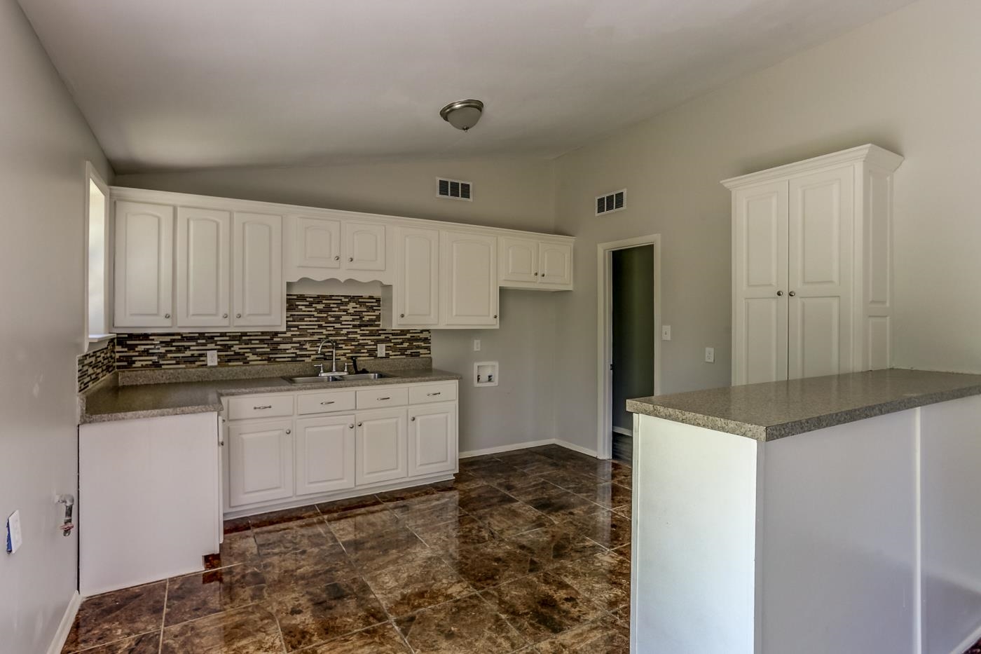 4566 Applegate Road Memphis, TN 38109 - Photo 10 of 25 a kitchen with granite countertop a sink and cabinets