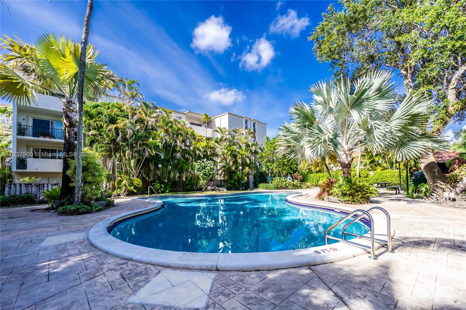 6902 North Kendall Drive, Unit E203 Pinecrest, FL 33156 - Photo 11 of 12 a view of a swimming pool with a patio