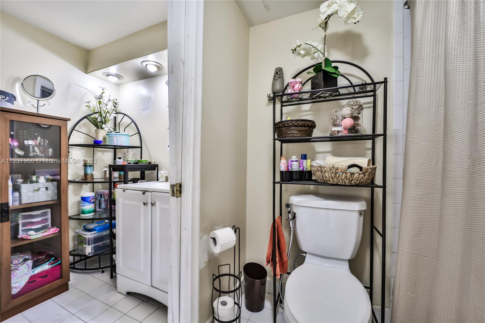 6902 North Kendall Drive, Unit E203 Pinecrest, FL 33156 - Photo 7 of 12 a room with a refrigerator and washer