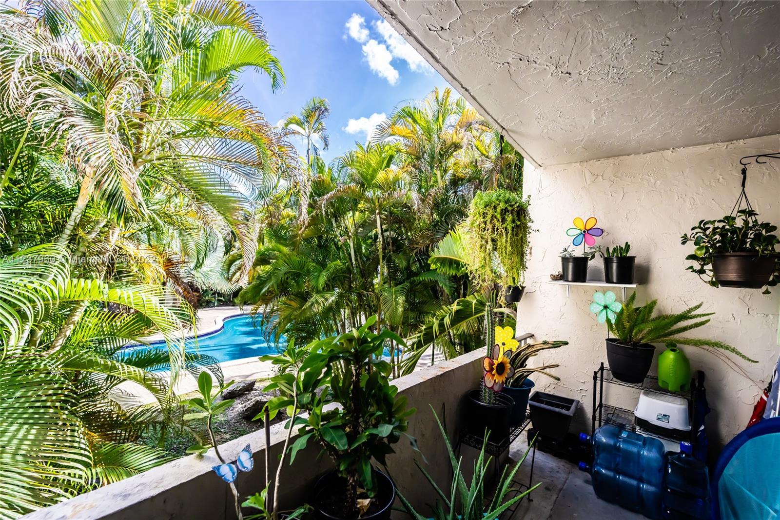 6902 North Kendall Drive, Unit E203 Pinecrest, FL 33156 - Photo 10 of 12 a plant is sitting in the middle of a house