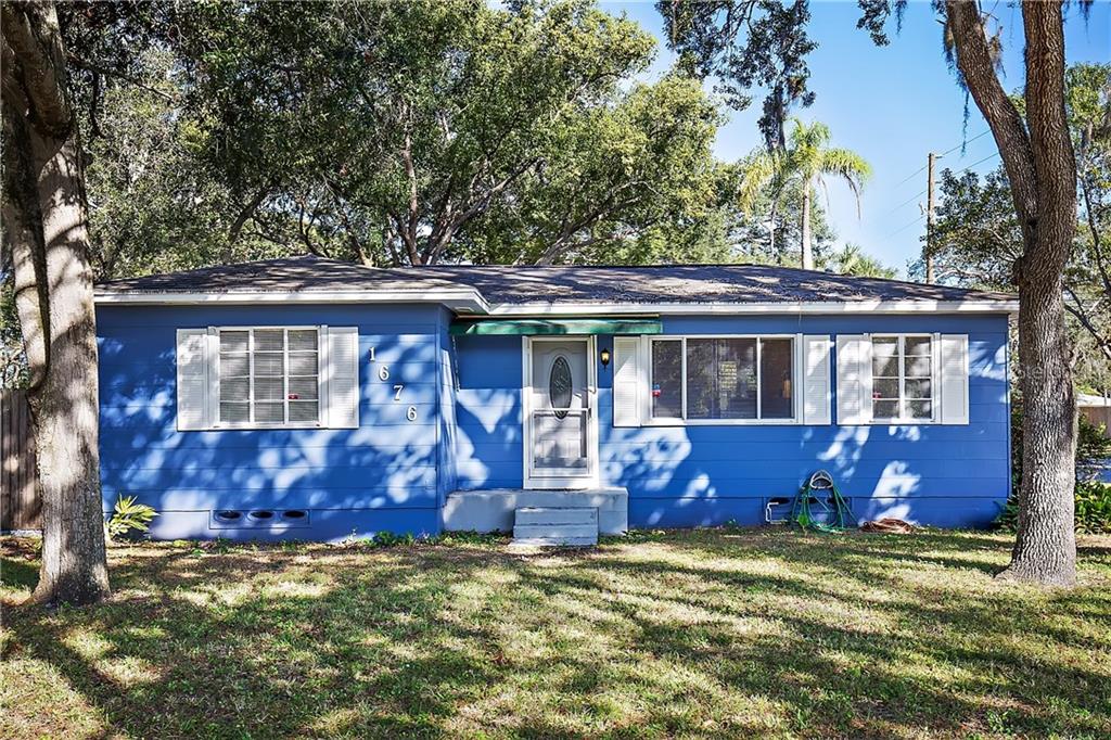 1676 Druid Road Clearwater, FL 33756 - Photo 1 of 1 a front view of house with outdoor seating