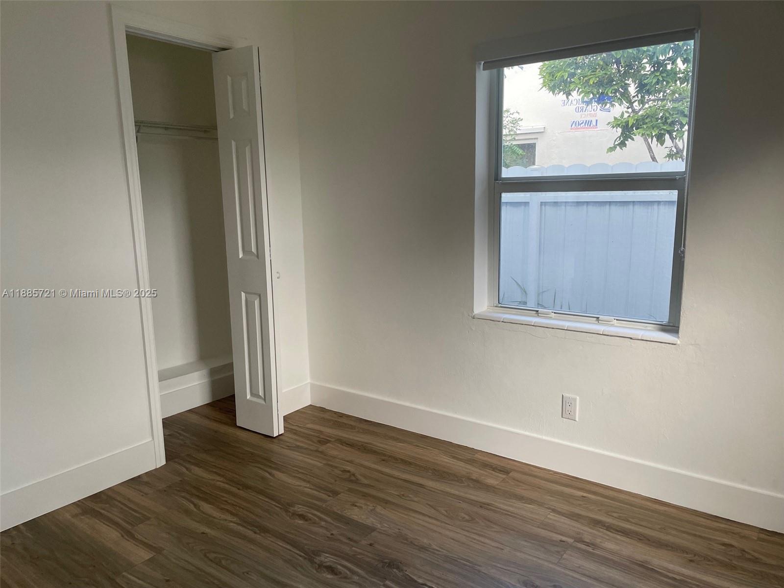 2434 Coolidge Street, Unit FRONT Hollywood, FL 33020 - Photo 13 of 18 an empty room with wooden floor and windows