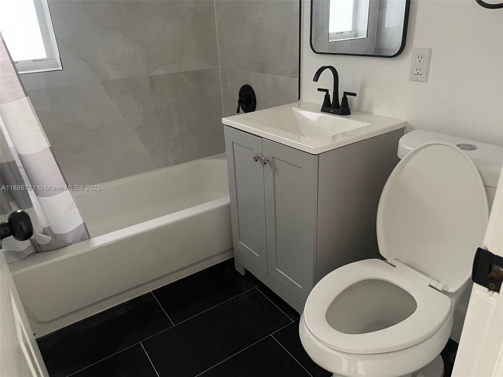 2434 Coolidge Street, Unit FRONT Hollywood, FL 33020 - Photo 16 of 18 a bathroom with a sink and a toilet