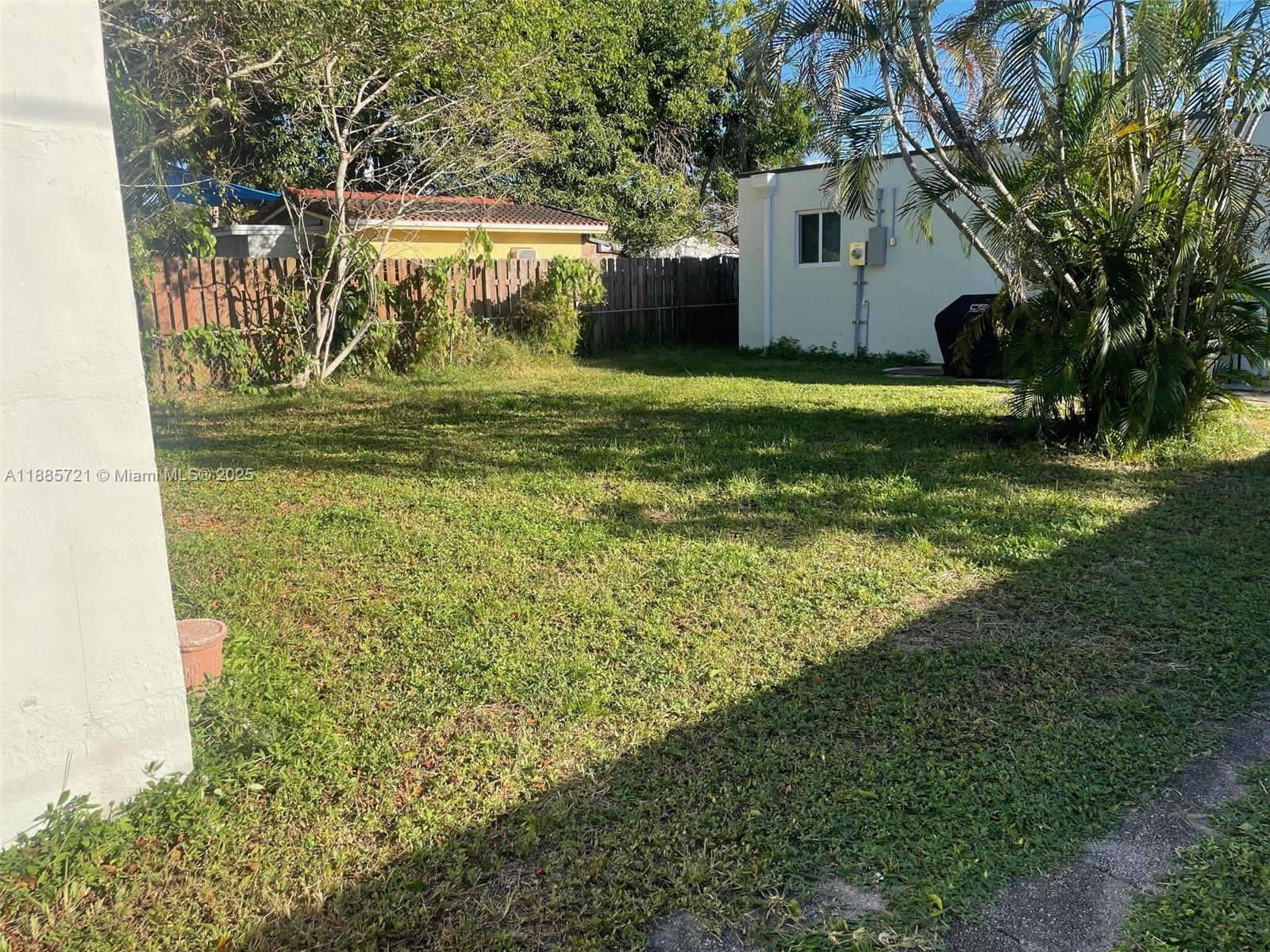2434 Coolidge Street, Unit FRONT Hollywood, FL 33020 - Photo 17 of 18 a view of a house with backyard and a tree
