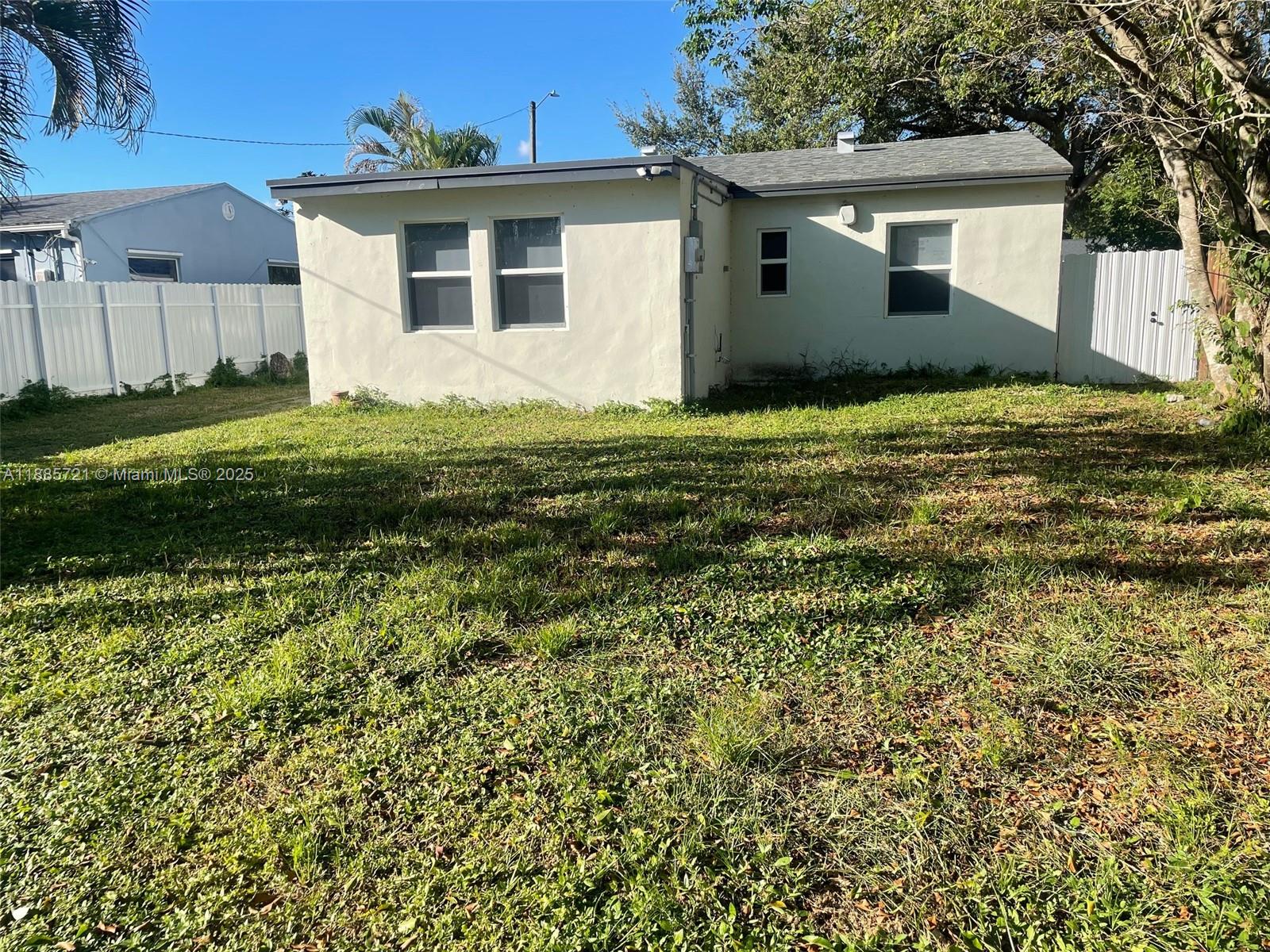 2434 Coolidge Street, Unit FRONT Hollywood, FL 33020 - Photo 18 of 18 a front view of a house with a yard