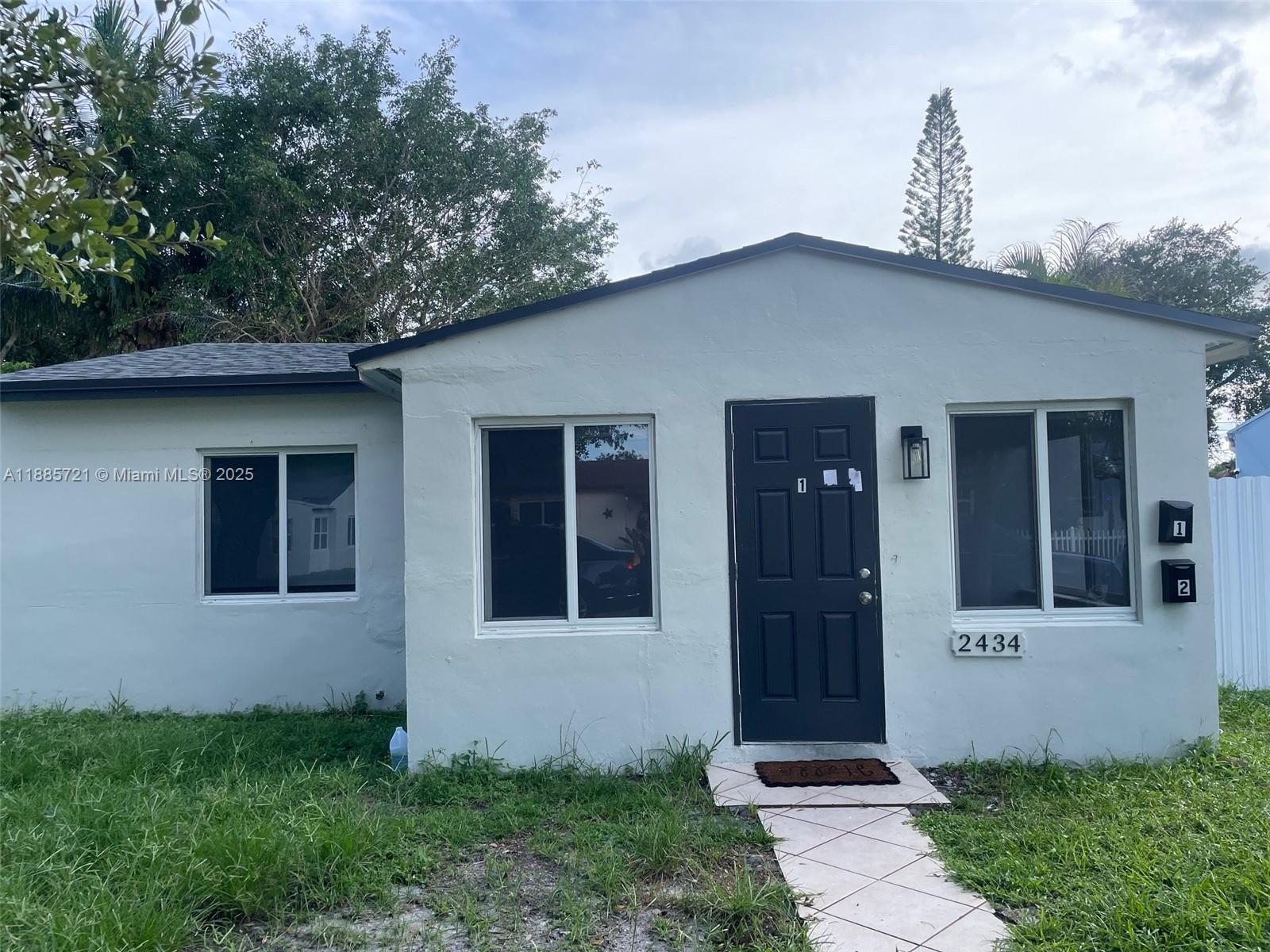 2434 Coolidge Street, Unit FRONT Hollywood, FL 33020 - Photo 2 of 18 a front view of a house with garden