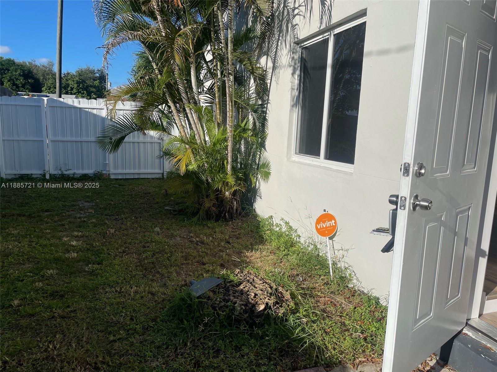 2434 Coolidge Street, Unit FRONT Hollywood, FL 33020 - Photo 3 of 18 a backyard of a house with lots of green space