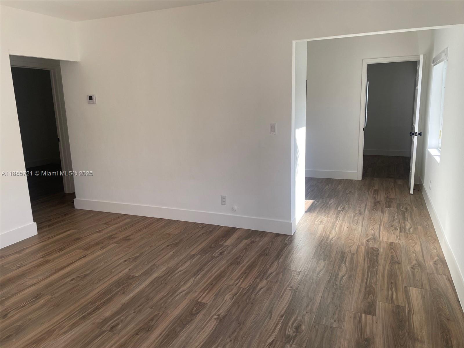 2434 Coolidge Street, Unit FRONT Hollywood, FL 33020 - Photo 8 of 18 an empty room with wooden floor and closet