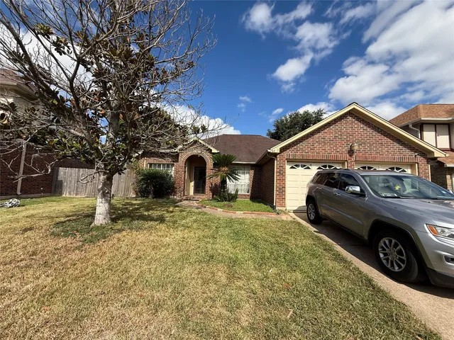 a view of a car parked in front of a house