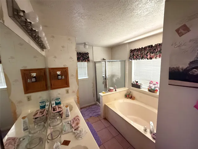 a bathroom with a tub sink and mirror