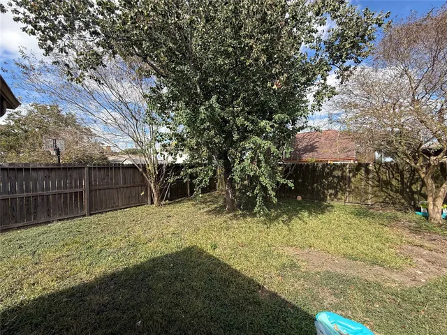 a backyard of a house with large trees