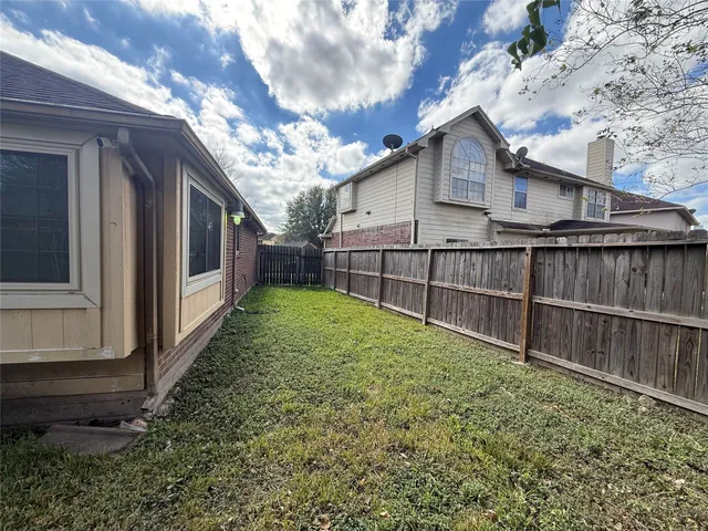 a view of a backyard with a large tree