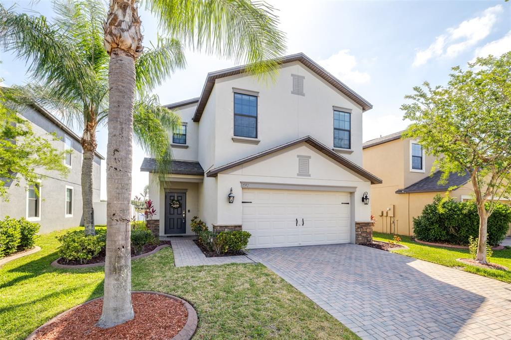 1762 Hadden Hall Place Trinity, FL 34655 - Photo 2 of 49 a view of a house with a yard and palm trees