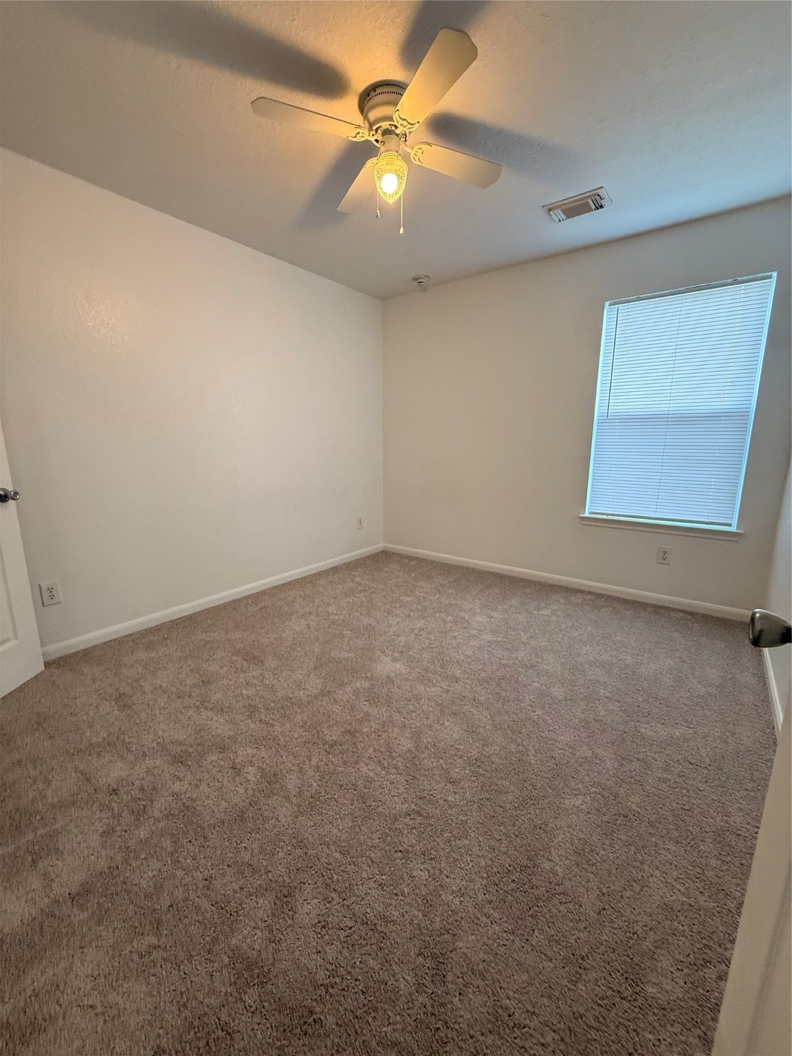 19410 Bold River Road Tomball, TX 77375 - Photo 14 of 25 an empty room with a window and a ceiling fan