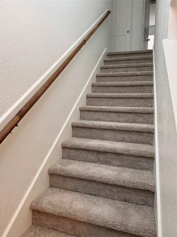 a kitchen with granite countertop a sink a stove and cabinets