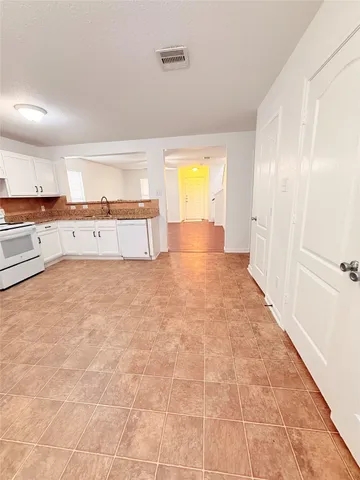 a view of a kitchen with a sink and a refrigerator