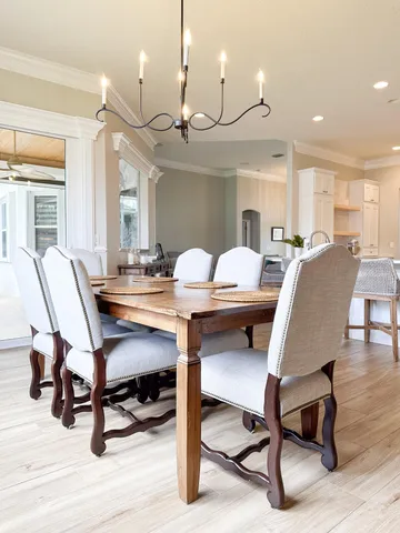a kitchen with stainless steel appliances a refrigerator stove and white cabinets