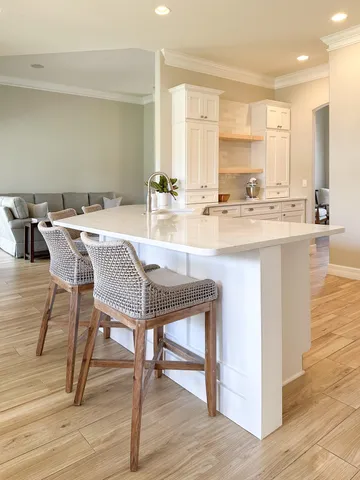 a spacious bathroom with a granite countertop sink and a mirror