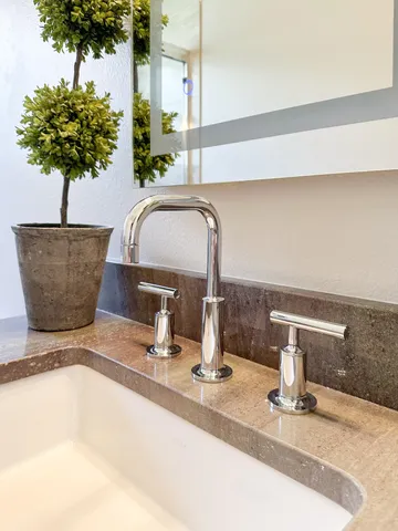 a bedroom with a bed and a night stand