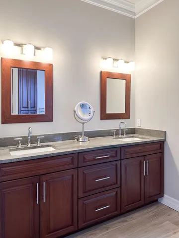 a view of a house with potted plants and a bench