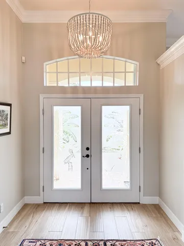 a kitchen with stainless steel appliances kitchen island granite countertop a dining table and chairs