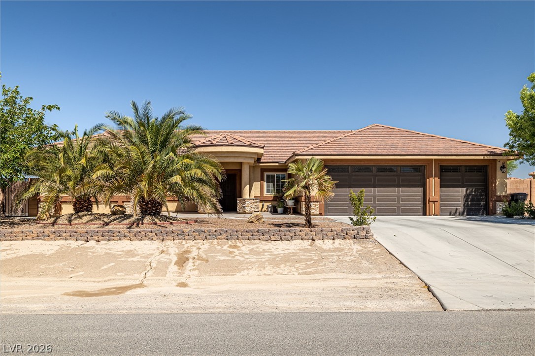 6720 Stubblefield Drive Pahrump, NV 89061 - Photo 1 of 51 An inviting exterior with a well-maintained yard and an integrated garage offers comfortable living.