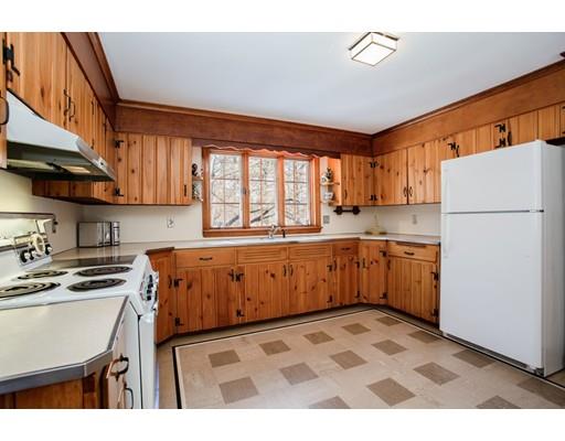 96 Roy Street Springfield, MA 01104 - Photo 11 of 27 a kitchen with a refrigerator a stove top oven a sink and cabinets