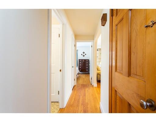 96 Roy Street Springfield, MA 01104 - Photo 14 of 27 a hallway with wooden floor and a bathroom